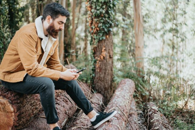 self-conscious young guy in woods