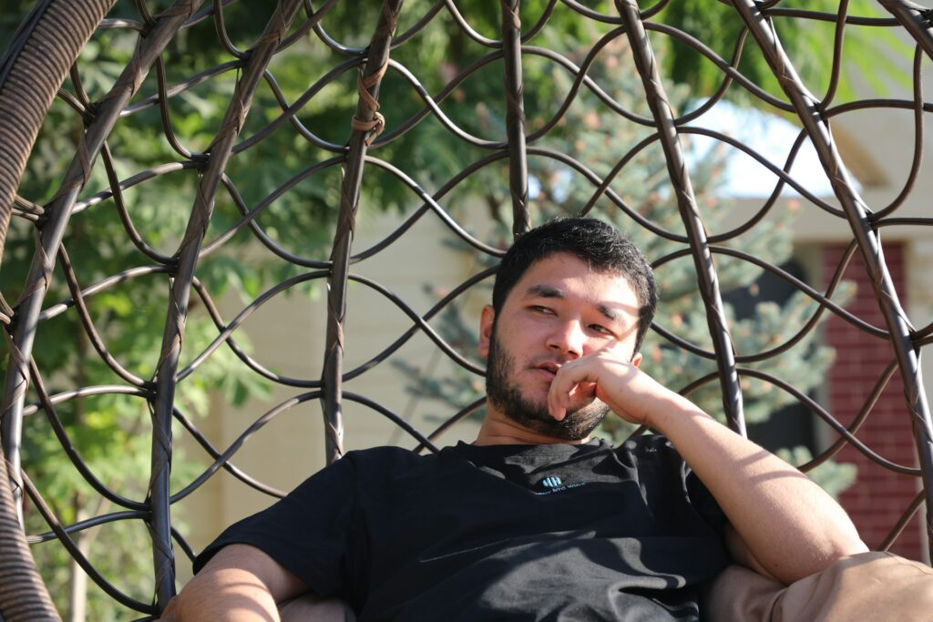 guy sitting in chair in garden