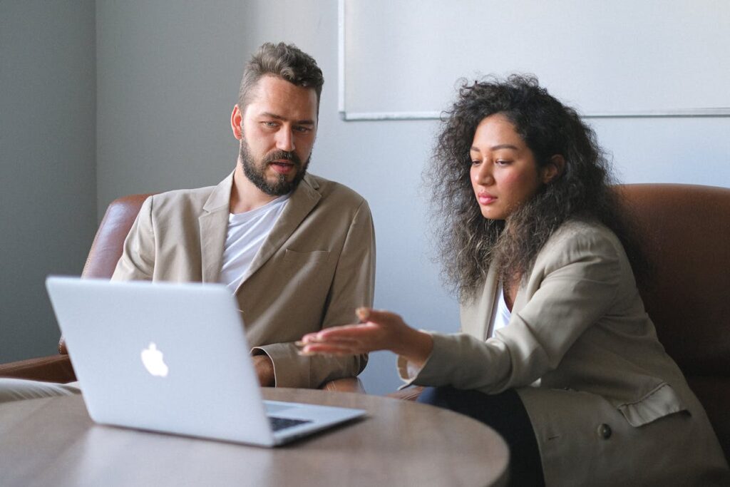 two colleagues looking at laptop